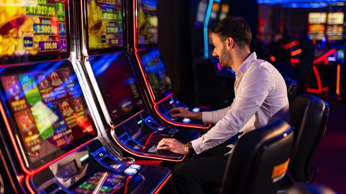 Man trying his luck on slot machines