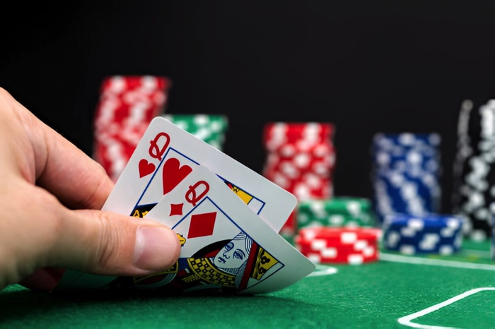 Poker hand showing a pair of queens
