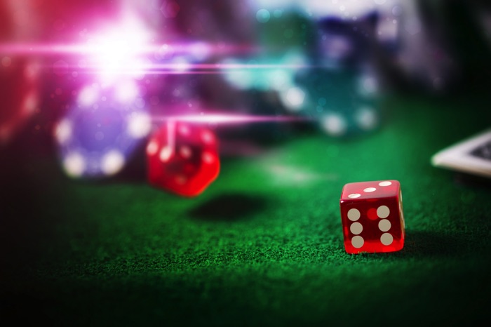 Red dice on green poker table